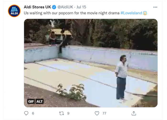 A tweet from @AldiUK with an image of a man standing and a caption of "Us waiting with our popcorn for the movie night drama #LoveIsland"