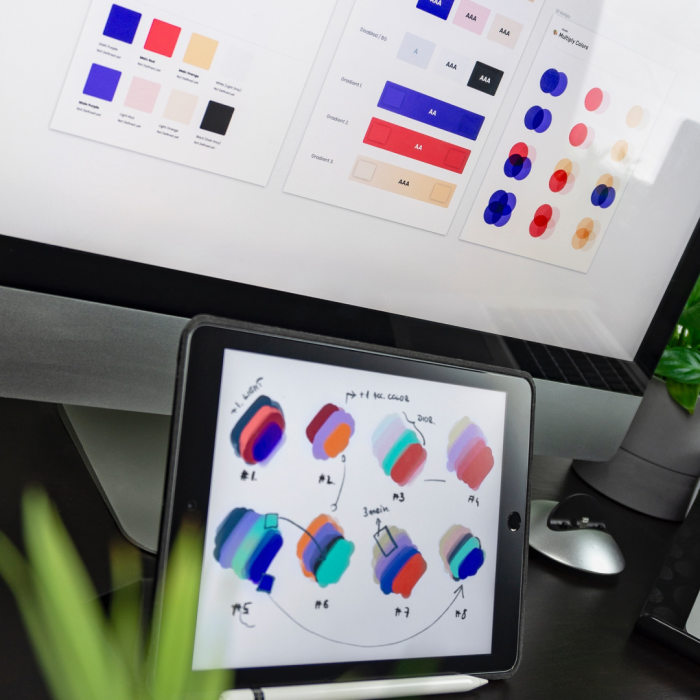 An iPad and monitor with colour schemes on it for branding. 