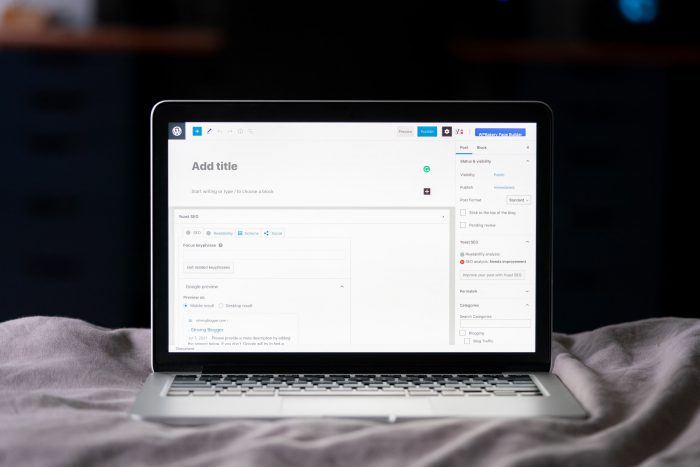 A laptop with a WordPress blog post on the screen